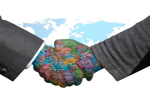 Shaking hands against map of the world background.